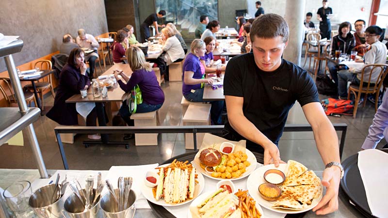 Student employee serving meals in Cultivate