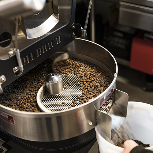 Coffee beans roasting in the roaster at Husky Grind