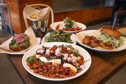 Multiple dishes sitting on table in Cultivate