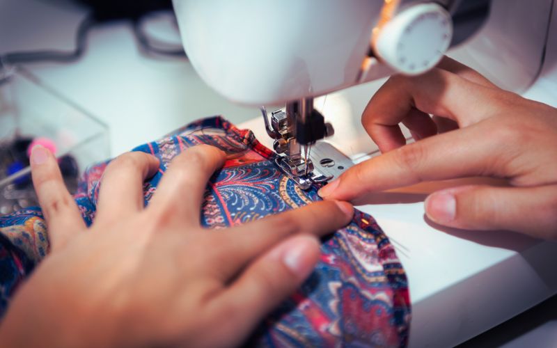 Hands at a sewing machine decorative