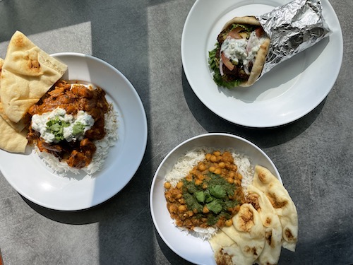 Three plates full of food.