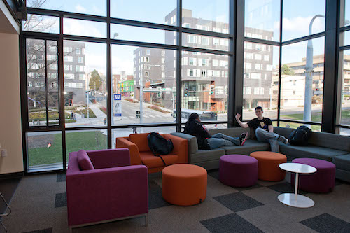 Students sitting in a residence hall lounge.
