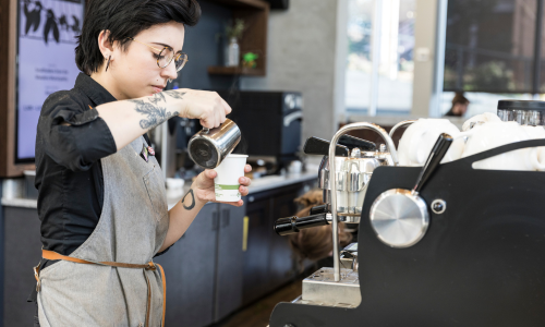 Husky Grind Coffee Woman making Latte
