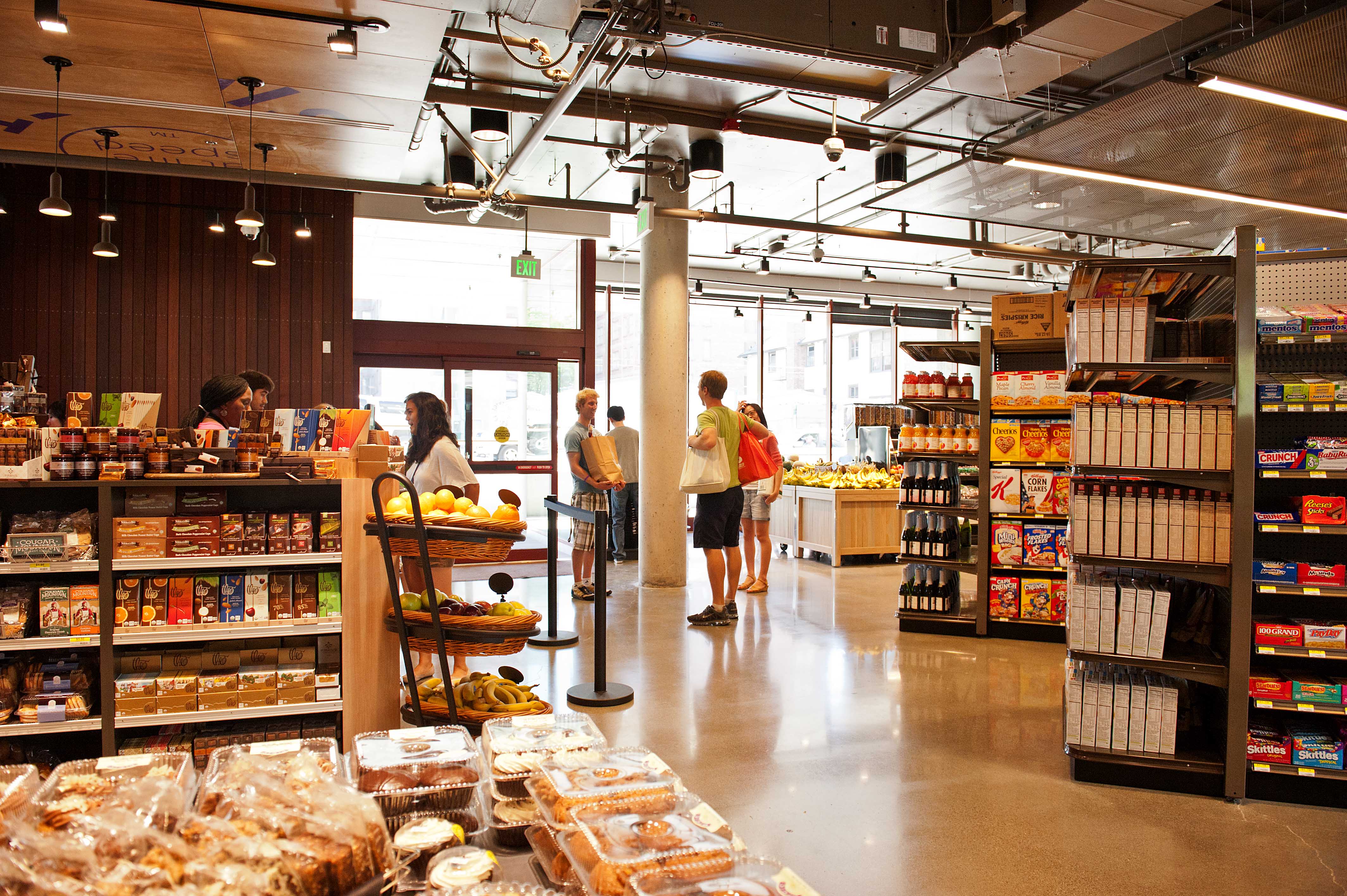 District Market Alder shoppers at register.