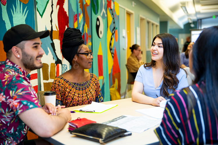 Students at a table discussing Living Learning Communities